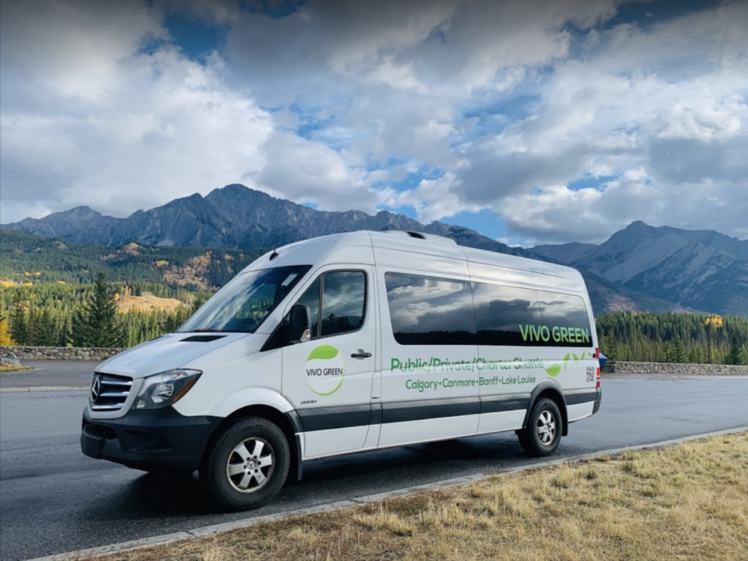 Vivo Green shuttle bus with mountain background