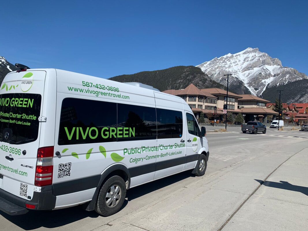 vivo green shuttle bus on road to canadian rockies